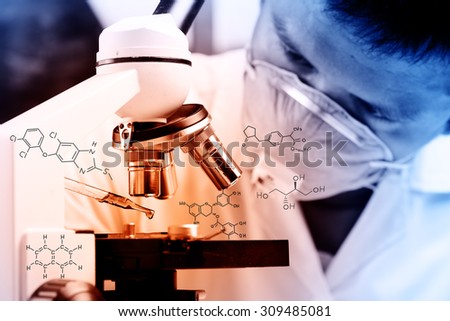 Scientist  dropping chemical liquid to microscope, Laboratory research concept;with chemical equations