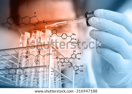 Laboratory pipette with drop of liquid over glass test tubes for an experiment in a science ,Researcher is dropping the reagent into test tube, with chemical equations background, in laboratory