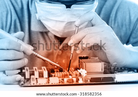 Technological background with closeup on tester checking motherboard. Electronics repair service, hands of female tech fixes an electronic circuit,computer technology concept