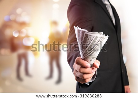 Businessman with money in hand, US dollar (USD) bills - investment, success and profitable business concepts