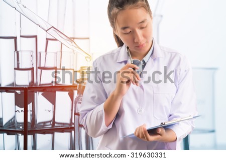 scientist thinking for writing report with equipment and science experiments