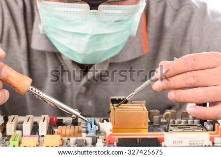 Technological background with closeup on tester checking motherboard. Electronics repair service, hands of female tech fixes an electronic circuit,computer technology concept