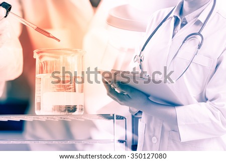 scientist writing report with equipment and science experiments;vintage process style
