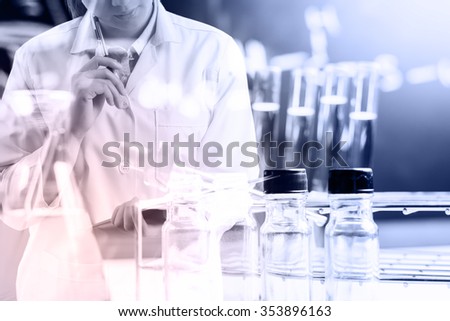 scientist writing report with equipment and science experiments, science research