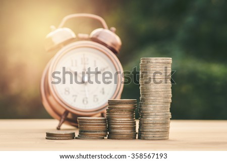 Close up of stacking gold coins with green bokeh background ,Business Finance and Money concept,Save money for prepare in the future.vintage process style