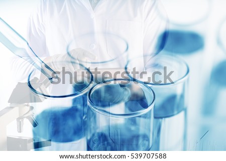 Double exposure of Scientists or doctor is using tablet with Laboratory glassware containing chemical liquid, science research concept,vintage process style