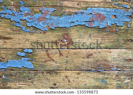 The old board with a hole, and paint remnants