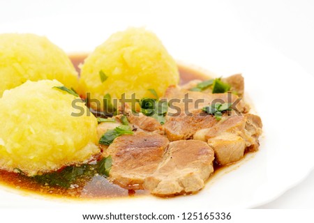 Meat with potato dumplings in dark sauce