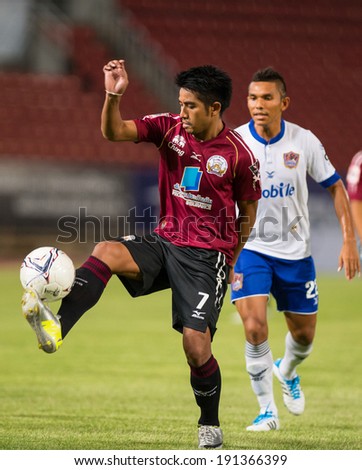 PATHUMTHANI THAI-MAY 05:Tana Chanabut(Crimson)of Police Utd. controls the ball playing during Thai Premier League match between Police Utd.and Songkhla Utd.at Thammasat Stadium on May 05,2014,Thailand