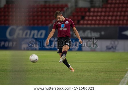 PATHUMTHANI THAILAND-MAY 05:Matej Rapnik of Police Utd.hit the ball during the Thai Premier League match between Police Utd.and Songkhla Utd.at Thammasat Stadium on May 05,2014,Thailand