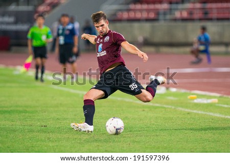 PATHUMTHANI THAILAND-MAY 05:Matej Rapnik of Police Utd. hit the ball during Thai Premier League match between Police Utd.and Songkhla Utd.at Thammasat Stadium on May 05,2014,Thailand