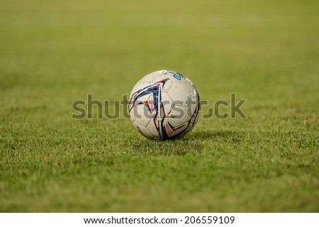 PATHUMTHANI THAILAND-Jul19:Football on lawn during the Thai Premier League between Police United and Sisaket FC at Thammasat Stadium on July 19,2014,Thailand