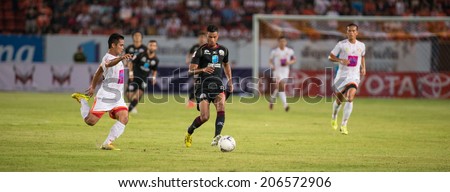 PATHUMTHANI THAILAND-Jul19:Michael Murcy(B)of Police Utd.runs for the ball during  the Thai Premier League between Police United and Sisaket FC at Thammasat Stadium on July19,2014,Thailand