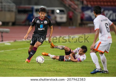 PATHUMTHANI THAILAND-Jul19:Pakorn Prempak(B) of Police Utd.contols the ball during the Thai Premier League between Police United and Sisaket FC at Thammasat Stadium on July19,2014,Thailand