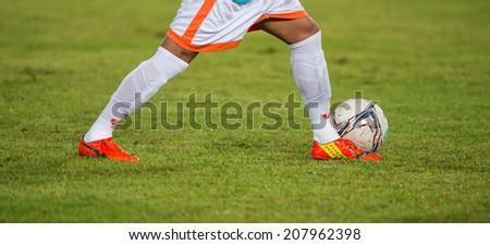 PATHUMTHANI THAILAND-Jul19:Football being kicked on lawn during the Thai Premier League between Police United and Sisaket FC at Thammasat Stadium on July19,2014,Thailand