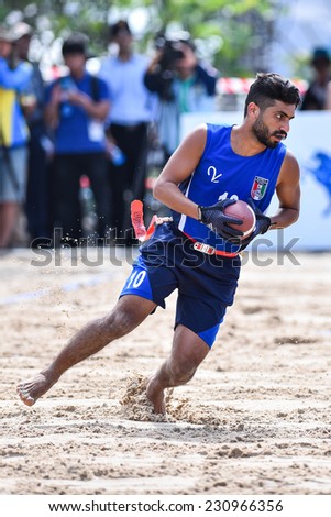 PHUKET,THAILAND-NOV14:Abdullah Dawoud of Kuwait run with the ball during the  Beach Flag Football Kuwait and Thailand during the 2014 Asian Beach Games at Saphan Hin on NOVEMBER 14,2014 in Thailand.