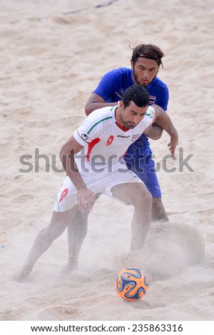 PHUKET THAILAND-NOV19:Mohammadali Mokhtari(W)of Iran compete for the ball during Beach Soccer match between Iran and Thailand the 2014 Asian Beach Games at Saphan Hin on November19,2014 in Thailand