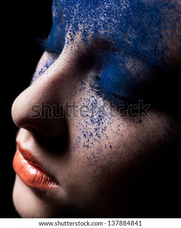 Beauty close-up portrait of beautiful woman model face with magic creative fashion colored make-up. Face painting, cosmetics, beauty and makeup.