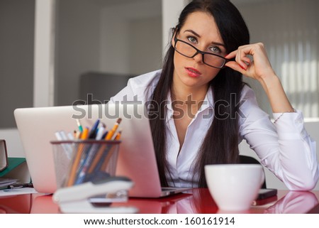 Beautiful secretary working in office with laptop computer.