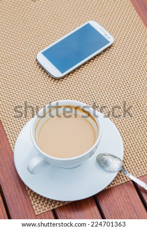Coffee and mobile phone on table