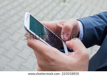 Close up of businessman hands with mobile phone. Copy space