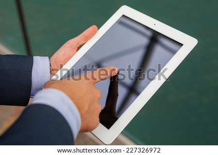 Close up of businessman hands with tablet pc. Copy space.
