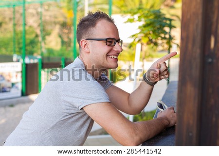 Man standing behind bar and ordering something