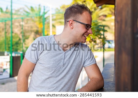 Man standing behind bar and ordering something