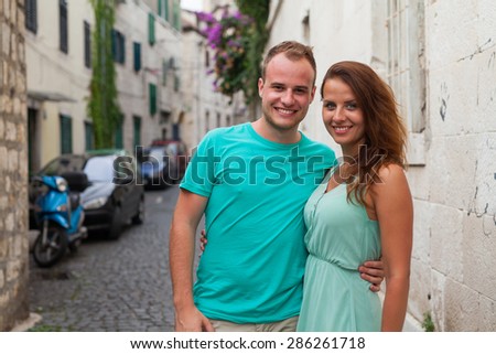 A couple standing on the street and having fun. Positive emotion