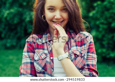 Brown hair girl   in the park and posing to the picture