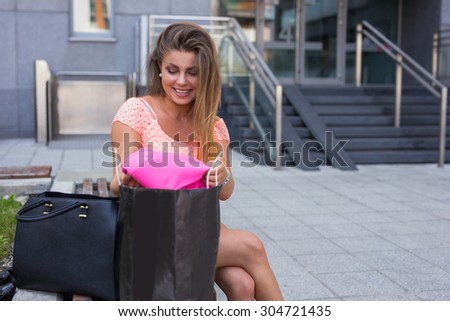 Young girl unpacking her shopping bags. Season of sales