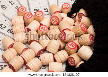 Lotto. Wooden kegs in a sack and game cards.