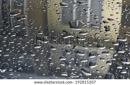 Reflection of house from water drops