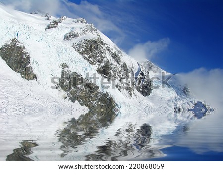 Ice mountain and reflection with blue skies