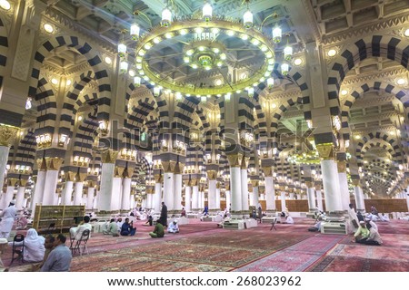 AL MADINAH, KINGDOM OF SAUDI ARABIA - MAR 07: Muslim pray and read Quran inside Masjid (mosque) Nabawi on March 07, 2015 in Al Madinah, S. Arabia. Nabawi mosque is the 2nd holiest mosque in Islam.