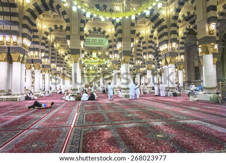 AL MADINAH, KINGDOM OF SAUDI ARABIA - MAR 07: Muslim pray and read Quran inside Masjid (mosque) Nabawi on March 07, 2015 in Al Madinah, S. Arabia. Nabawi mosque is the 2nd holiest mosque in Islam.