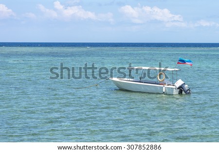 Boat with clean water and blue skies