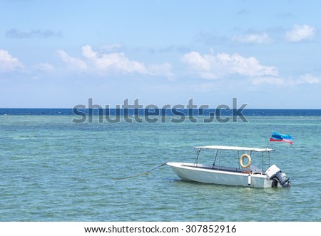 Boat with clean water and blue skies