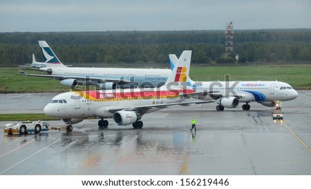 MOSCOW - SEPTEMBER 6: IBERIA, YAMAL and CATHAY PACIFIC airlines in Domodedovo International, Moscow on Sept. 6, 2013. Airport activity: arriving YAMAL and departing IBERIA airlines in Domodedovo Int.