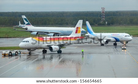 MOSCOW - SEPTEMBER 6: IBERIA, YAMAL and CATHAY PACIFIC airlines in Domodedovo International, Moscow on Sept. 6, 2013. Airport activity: arriving YAMAL and departing IBERIA aircrafts in Domodedovo Int.