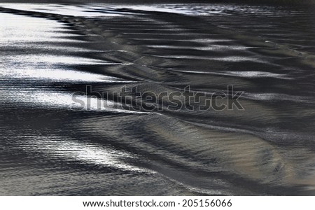 A chain of volumetric night waves under the abstract moonlight, inverted and tinted image. Waves: relief on the water surface, a series of images