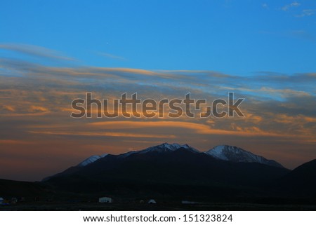 Beautiful sunset glow with orange clouds on Tibetan Plateau