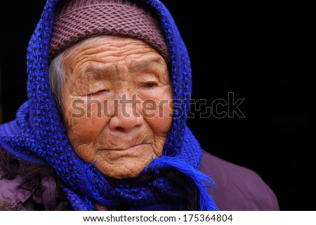 Portrait of a 95 years old woman, born in 1919, with depression,  the last generation that bind the feet of woman