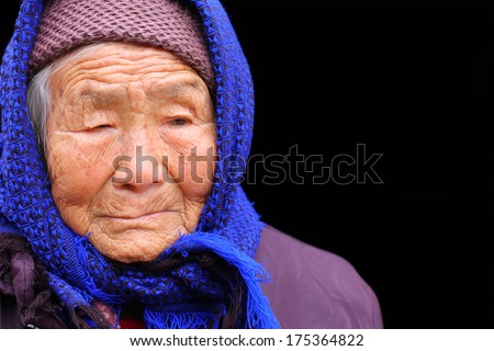 Portrait of a 95 years old woman, born in 1919, with depression,  the last generation that bind the feet of woman
