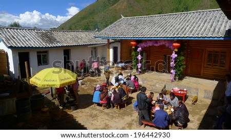 LIJIANG, CHINA - SEPTEMBER 19: Unidentified Mosuo Minority People attend a wedding ceremony and wedding feast, September 19, 2013, Yongning, Linlang, Lijiang, Yunnan, China
