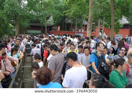 LESHAN, CHINA - MAY 24: Unidentified believers line up a long queue and wait to visit the UNESCO world heritage Giant Buddha, Leshan, Sichuan, China, May 24, 2014