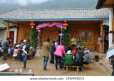 LIJIANG, CHINA - SEPTEMBER 19: Unidentified Mosuo Minority People attend a wedding ceremony and wedding feast, September 19, 2013, Linlang, Lijiang,Yunnan, China