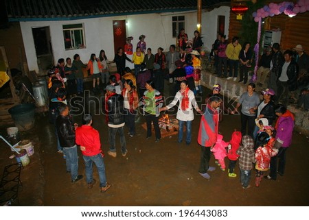 LIJIANG, CHINA - SEPTEMBER 19: Unidentified Mosuo Minority People dance around the bonfire, so called Guozhuang, after a wedding ceremony, September 19, 2013, Yongning, Linlang, Lijiang, Yunnan, China