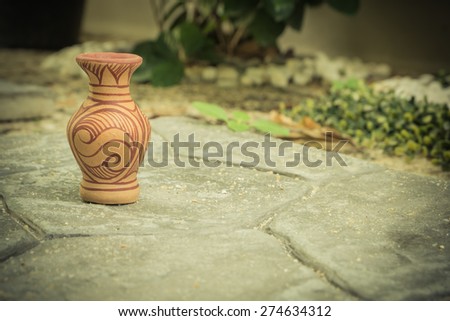 Pottery Vase on rocky ground.
