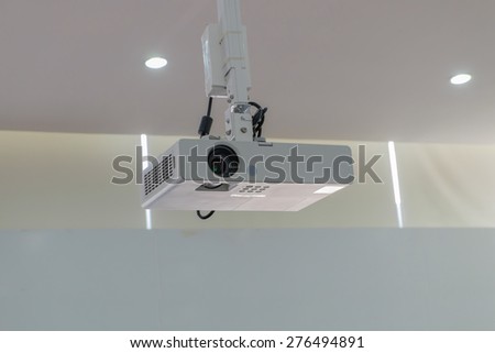 A white overhead projector on ceiling indoors